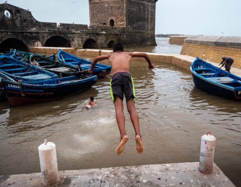 Kids jumping in the port of Essaouira