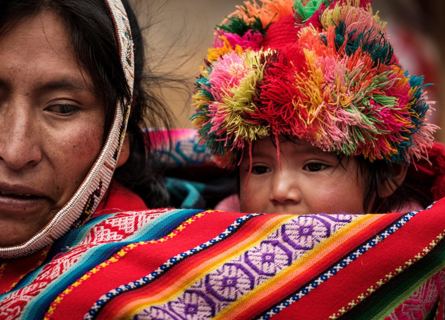 OLLANTAYTAMBO, PERU - CIRCA SEPTEMBER 2019: Portrait of a baby and mother from the andean community of Willoq close to Ollantaytambo in the Sacred Valley of Peru.
