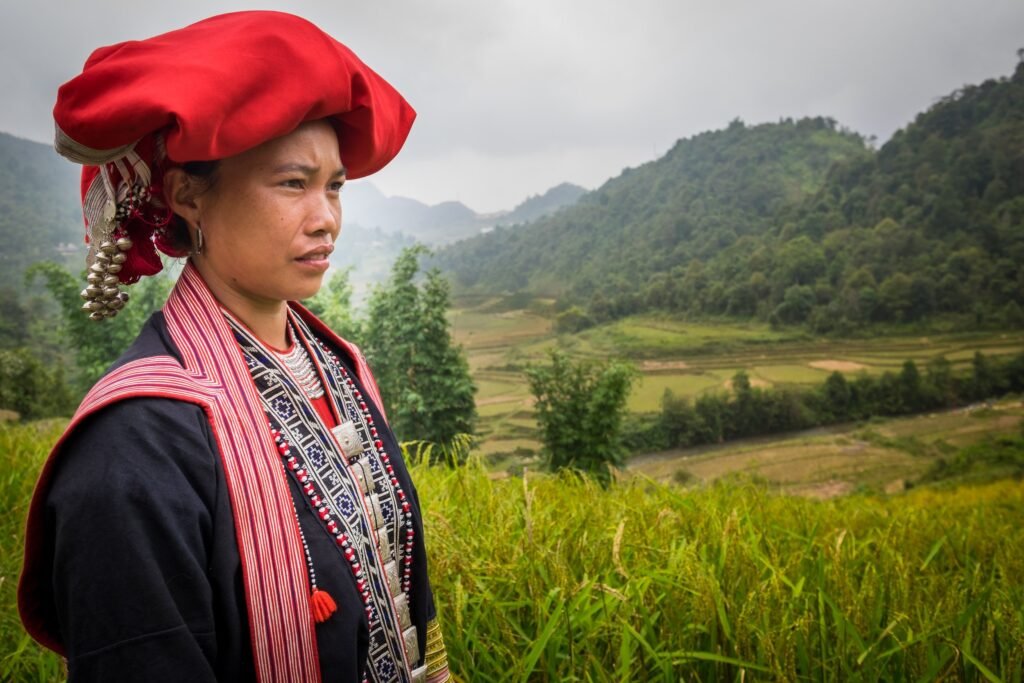 SAPA, VIETNAM - CIRCA SEPTEMBER 2014: Young woman from the Red Dao minority on the rice fields in Ta Phin Village near Sapa, north Vietnam.
